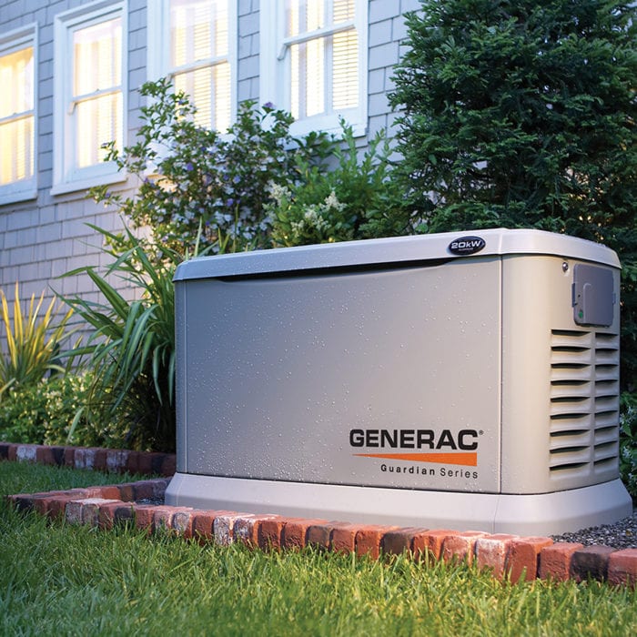 Technician from Generator Supercenter of Peabody professionally installing a standby generator outdoors.