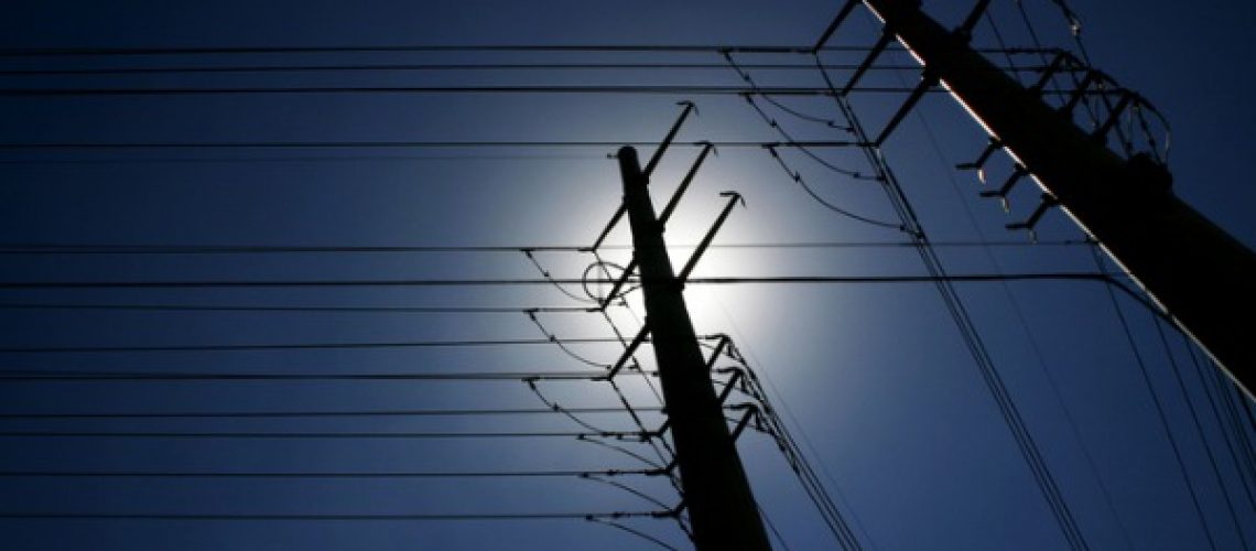 maze-of-power-lines-against-deep-blue-sky-picture-id179268840